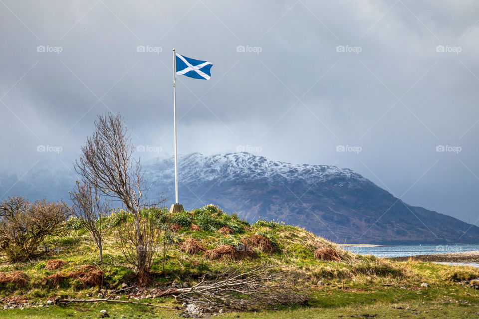 Scottish flag flying near Eilean Donan Castle