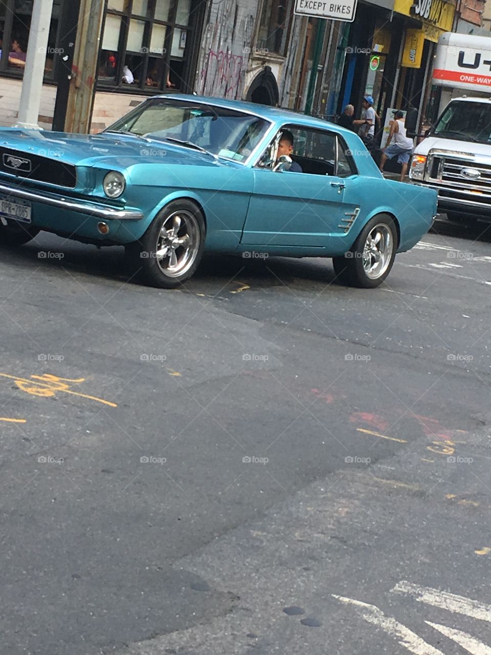 Here we have a classic mustang posed like a good movie action scene. This new york city street makes everything look a little more vintage. Have fun with this photo. 