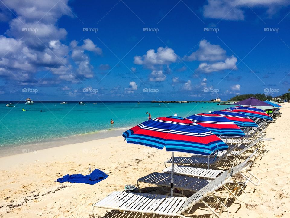 Lounge chairs and umbrellas on sand at beach