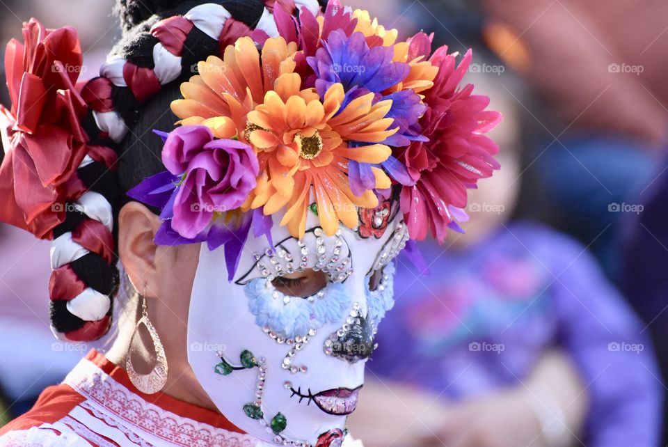 A dancer with flowers and mask