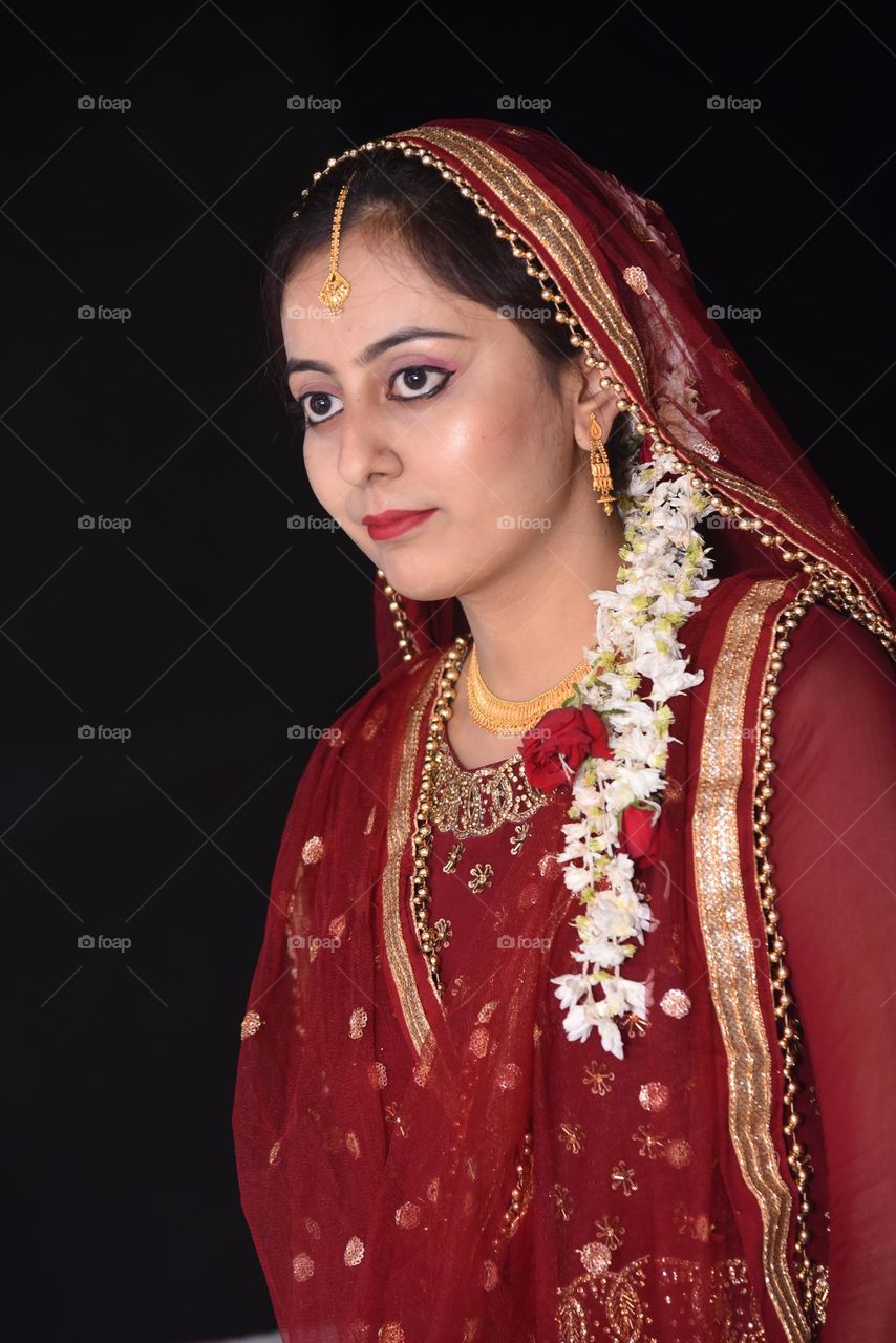 Portrait of a lady wearing heavy gold jewellery