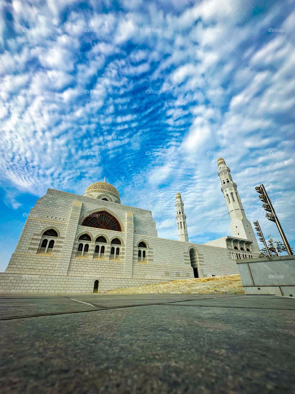 A low-angle, wide shot of the Mohammed Al Ameen Mosque in Muscat, Oman.