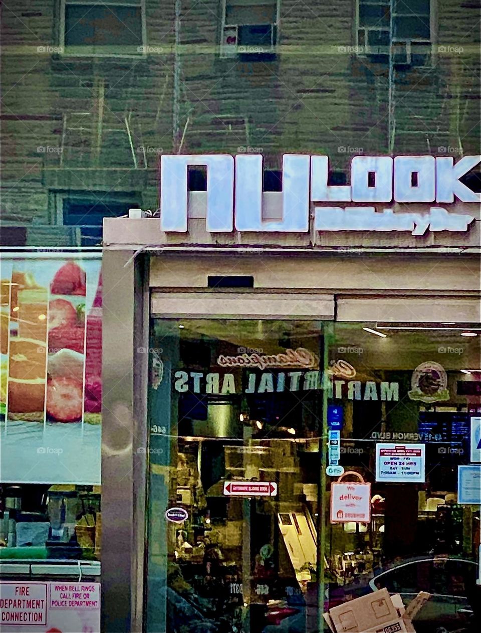 This small slice of Long Island City, Queens, NY can be seen in the shop window to this grocery store and everything else that happens to be reflected therein from across the street and elsewhere. 2022. Hypnotic Productions