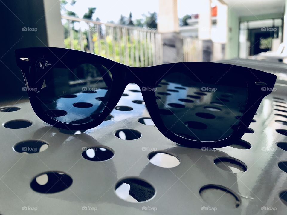 Sunglasses on a bench