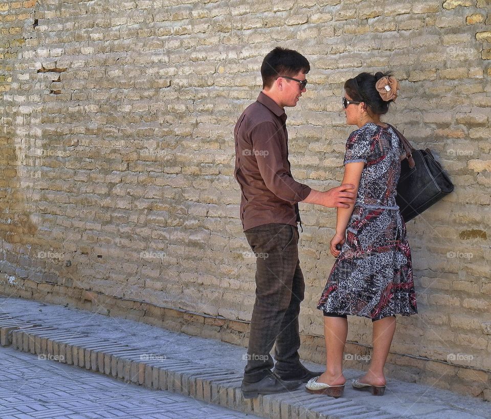 I still love you. . This couple live in Uzbekistan. They either came to Khiva as tourists or may be its their hometown. I saw this young man and a woman talking and it seamed to me that he is guilty for something and asking her forgiveness. She is still angry with him but she didn't leave. I didn't wait up until that conversation was over. I just took that picture and went on. It's nice they were so busy with themselves and didn't pay attention to me. 