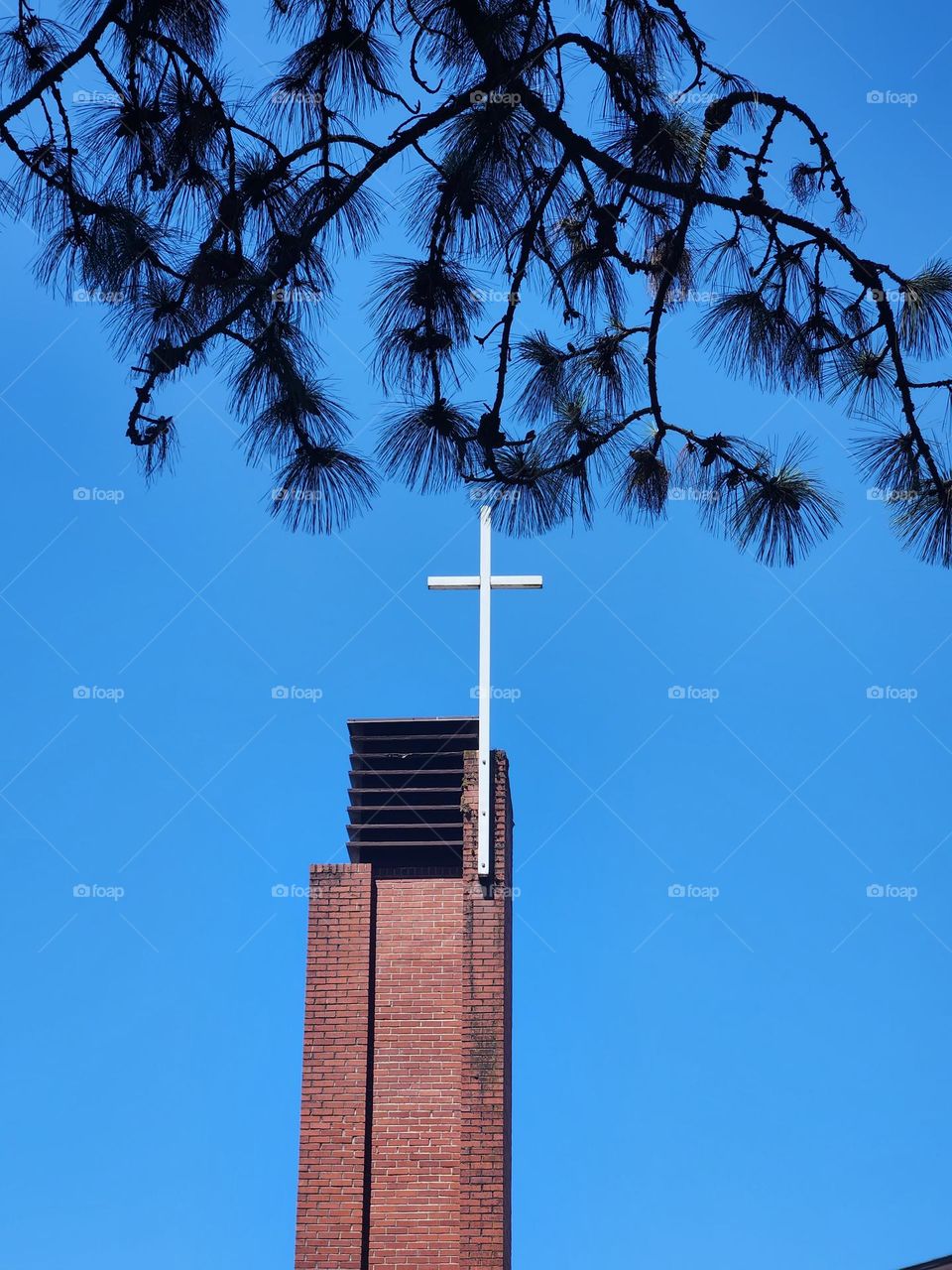 white cross on church building against blue sky in Oregon