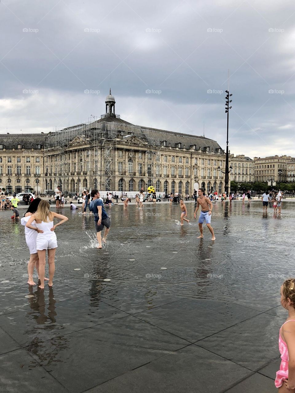 People playing football in fountain in city fountain in Bordeaux 
