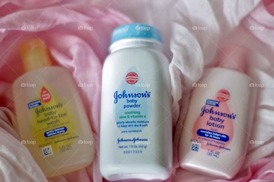 Johnson and Johnson baby products on a pink background flat lay 