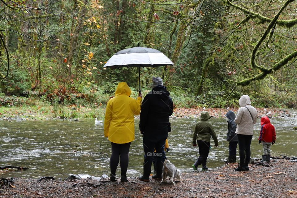 People by the river on a rainy day