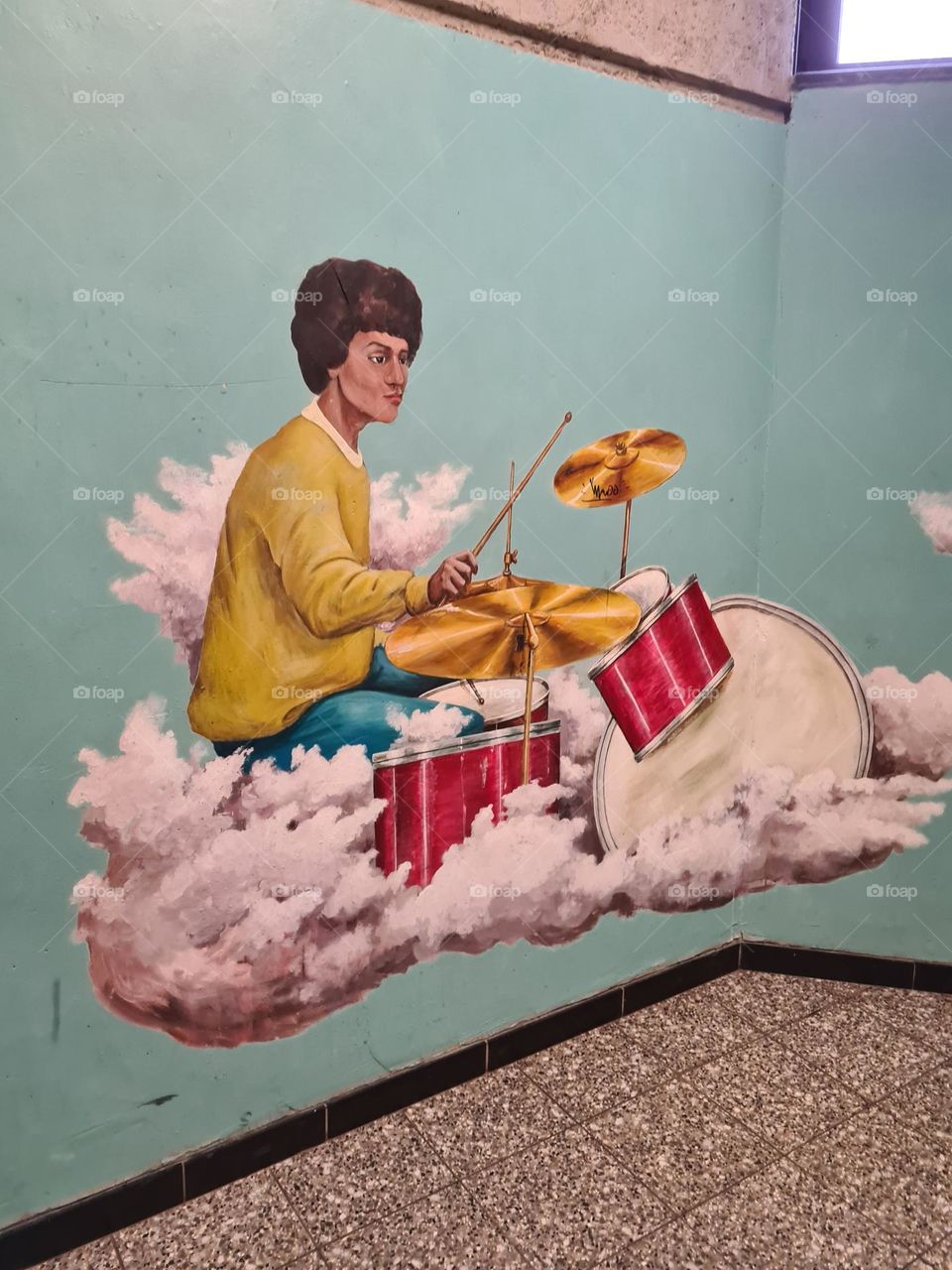 A drummer playing on the clouds.! This was made by students from a school out of German.