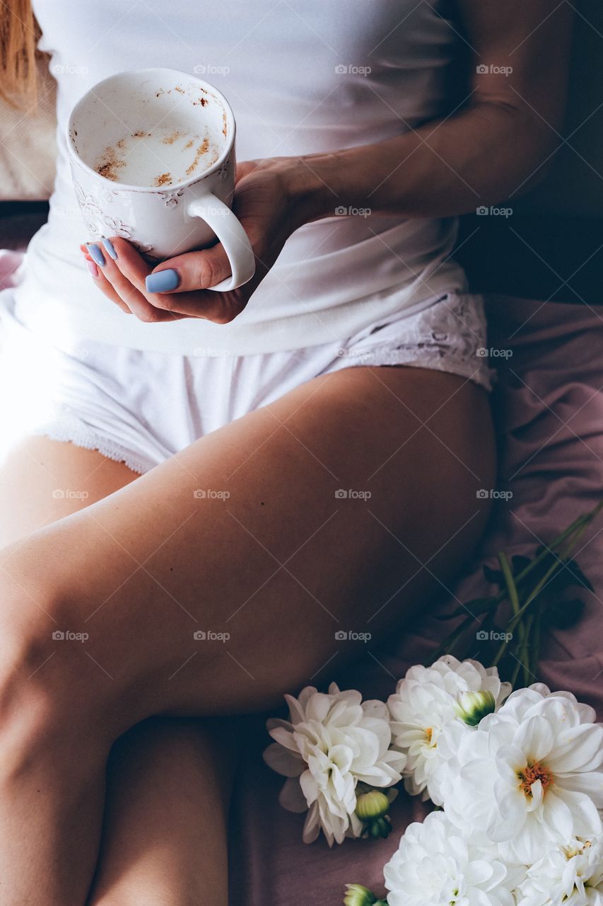 Woman's hand holding cup of coffee