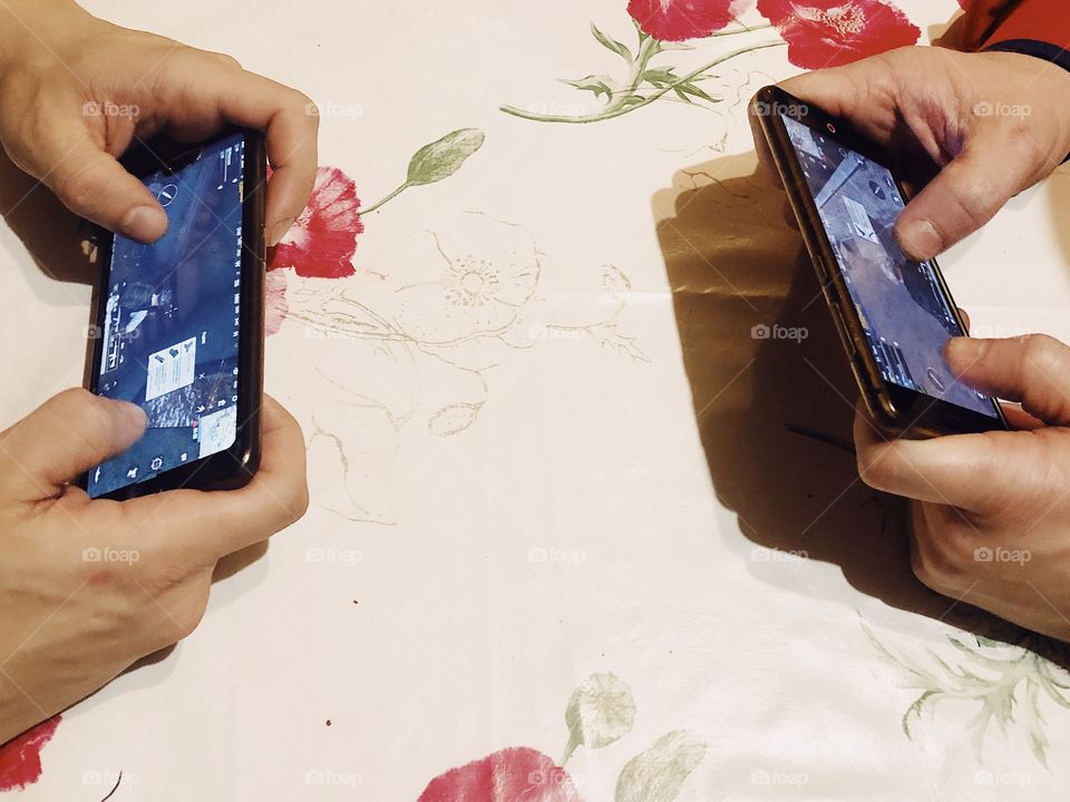 People gaming PUGB with smartphones