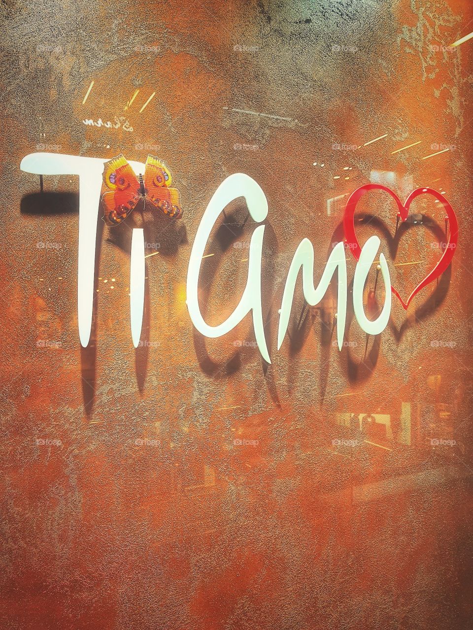 The inscription in Italian I love you. Orange background