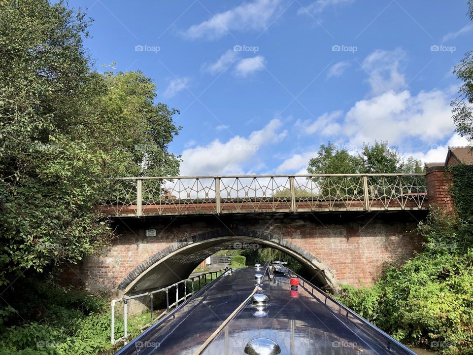 Cool bridge on Oxford canal near Ansty clear sky narrowboat cruise sunny late summer weather vacation holiday historic waterway