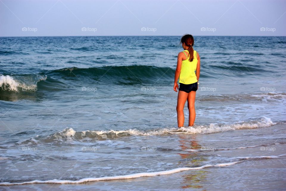 Girl standing in ocean