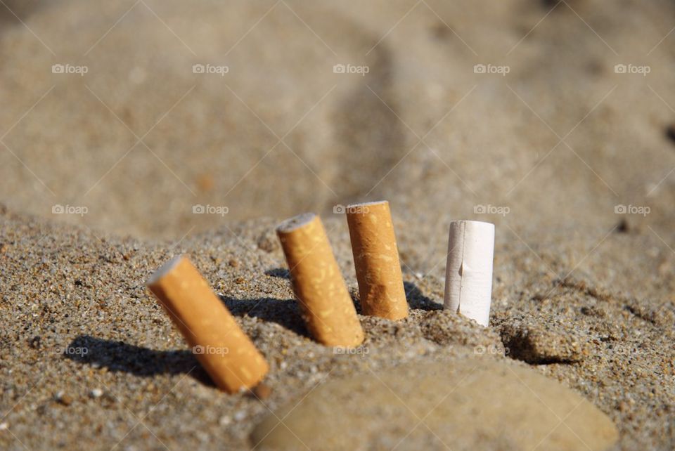 Cigarette butts in the sand