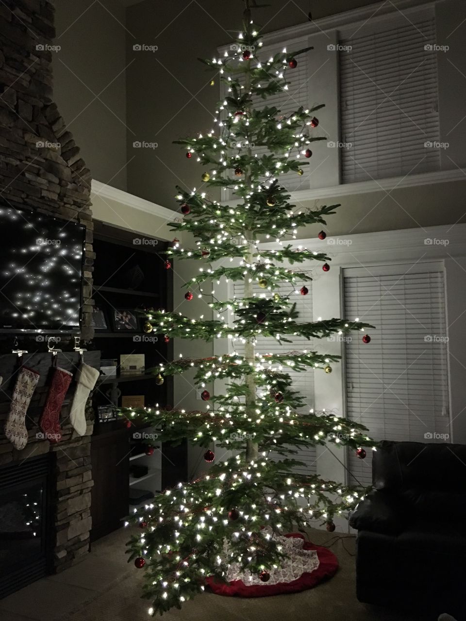 Christmas tree near fireplace