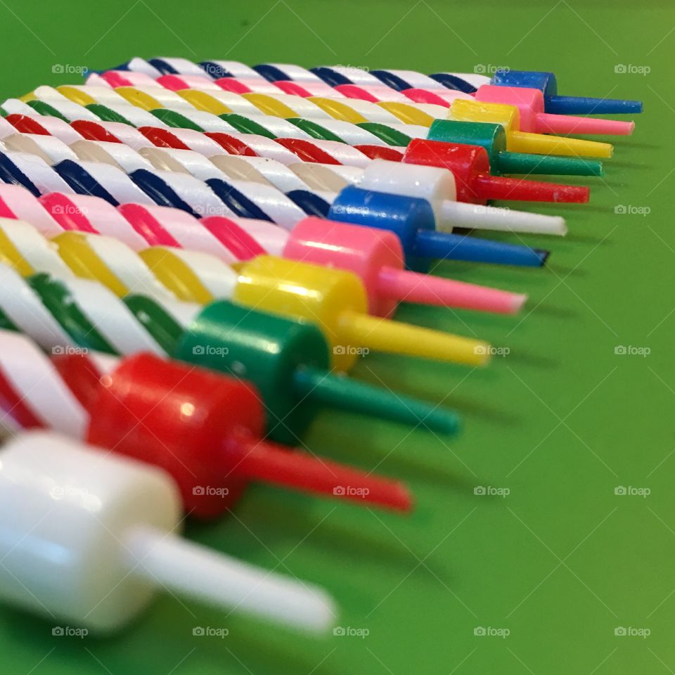 Swirl candles on green table.