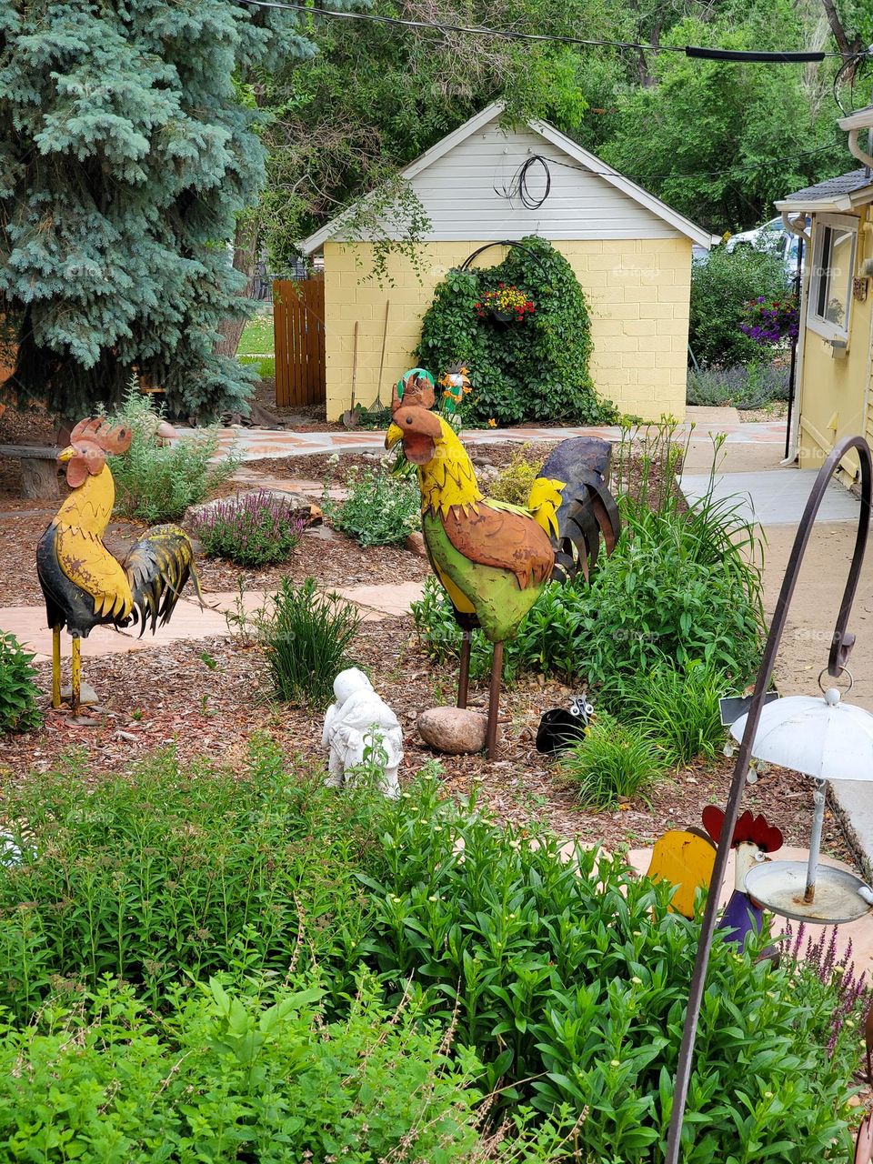 Several fun and whimsical sculptures fill a front yard
