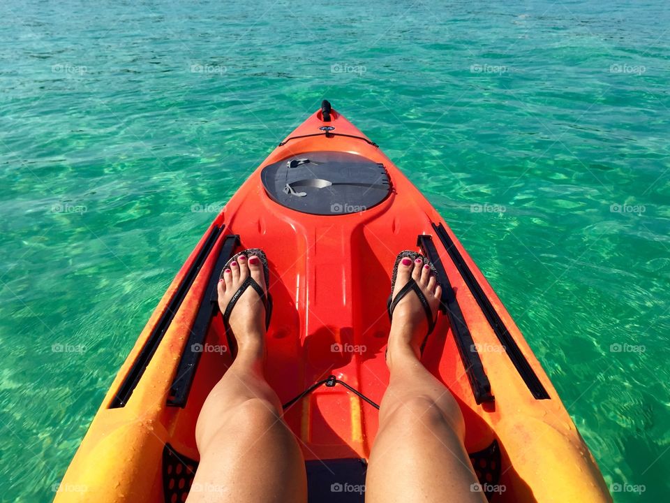 Woman's legs on kayak in sea
