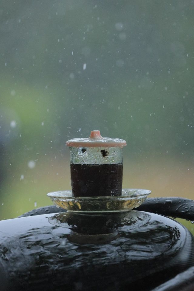 A cup of black coffee under the rain