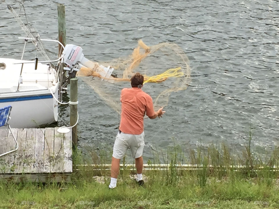 Man throwing casting net
