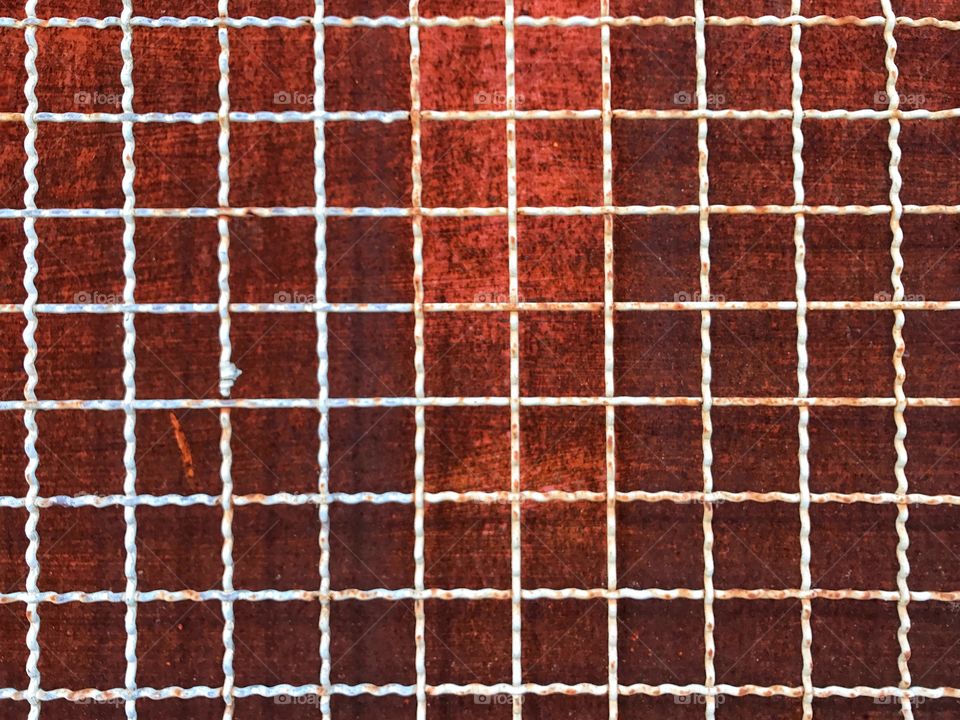 Vintage  iron cage on rust metal background texture