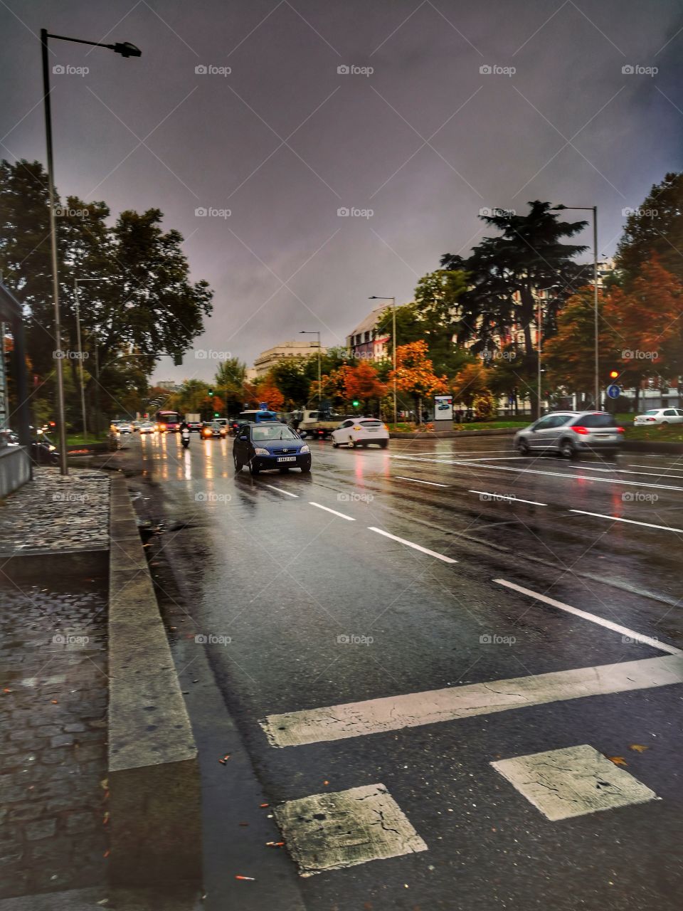Car driving on road during rainy season