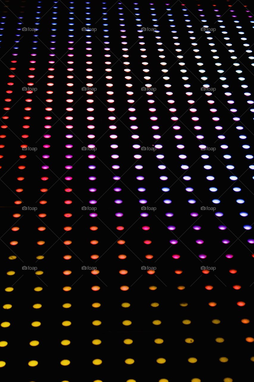 Angular view of multi-colored lighted circles on black background