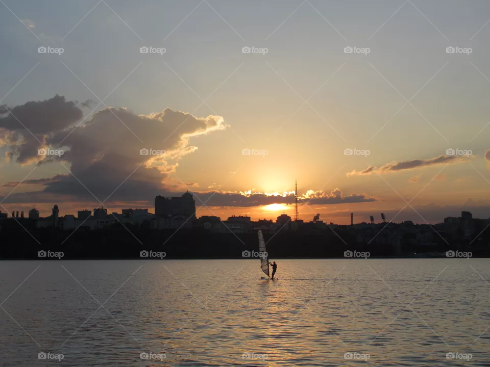 sunset and windsurfing on the river