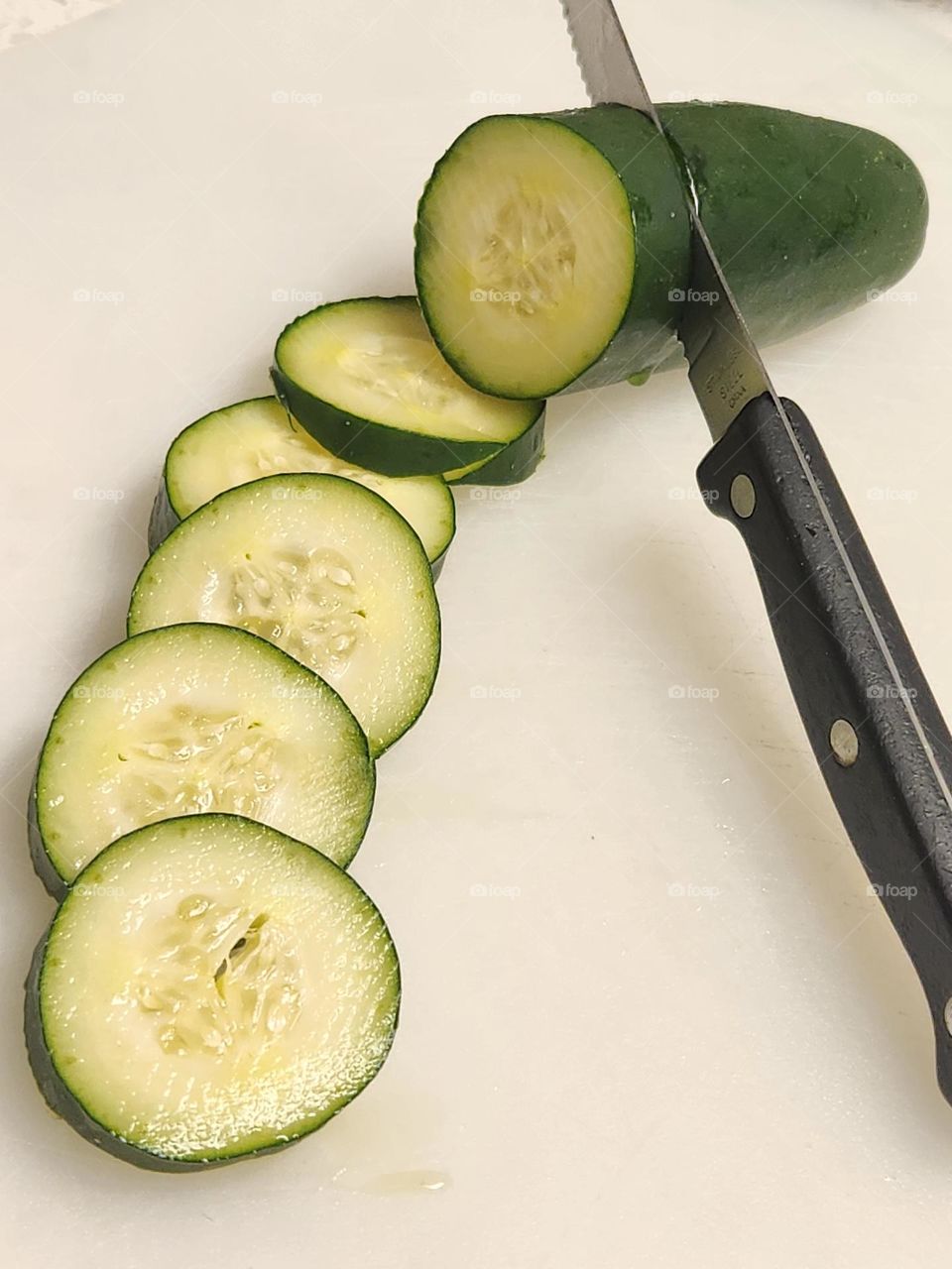 kitchen meal prep knife slicing cucumber