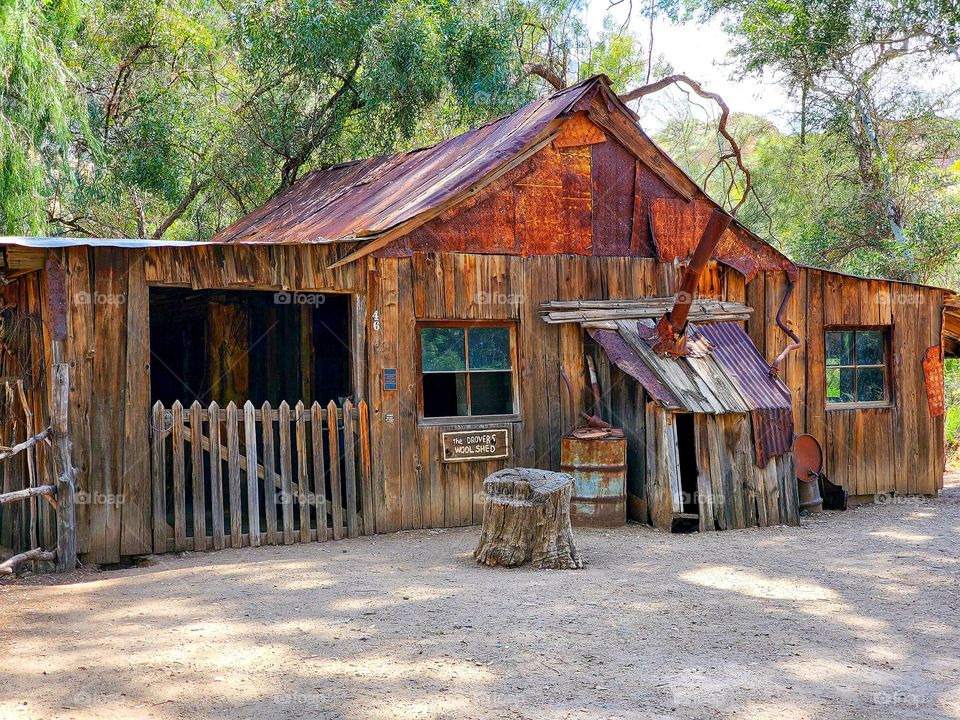 A peaked roof on a rusty metal ranch building creates a perfect triangle in order to shed water and debris