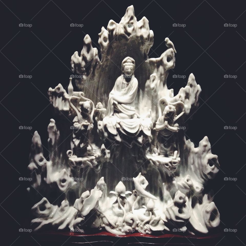 A porcelain sculpture of Buddhist goddess Guanyin in a grotto.
