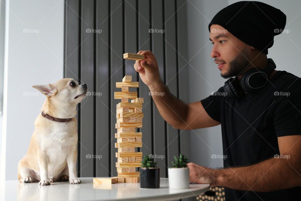 Boy of twenty five years spend time with his dog together at home