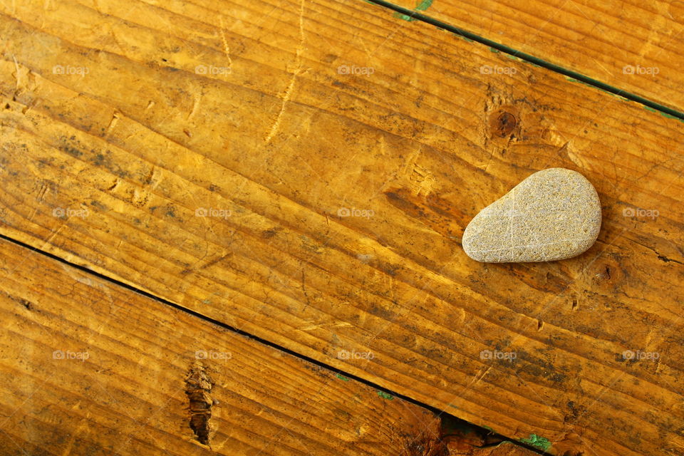 stone on wooden table