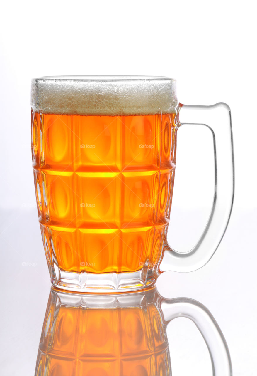 Beer mug / glass with forth on white reflective background