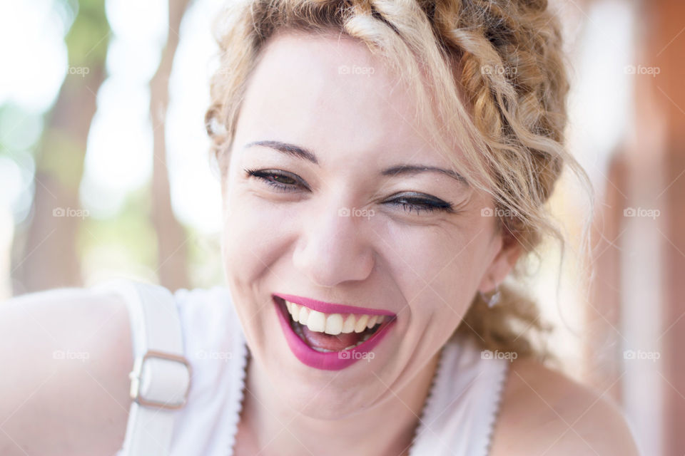 girl laughing. curly blond girl having fun and laughing