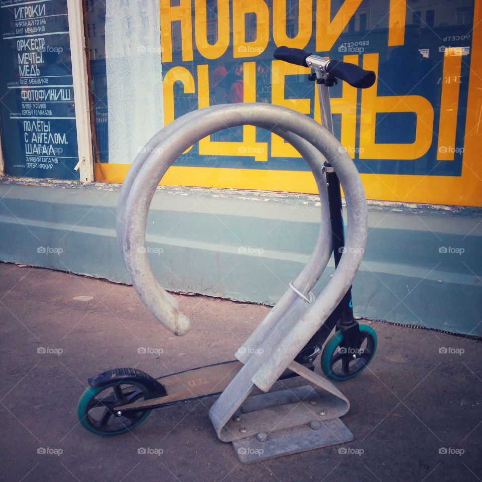 Small scooter standing near bike rack parking place in Moscow, Russia