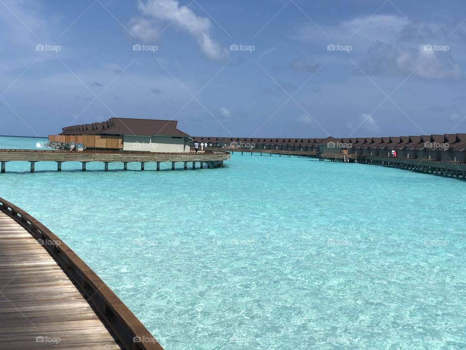 Ocean pool villas #carpe-diem. All you can see are naturally white sand beach and beautiful shades of blue. In the distance, the ocean and horizon blend and the colours transition with the hours from blue to red to black.