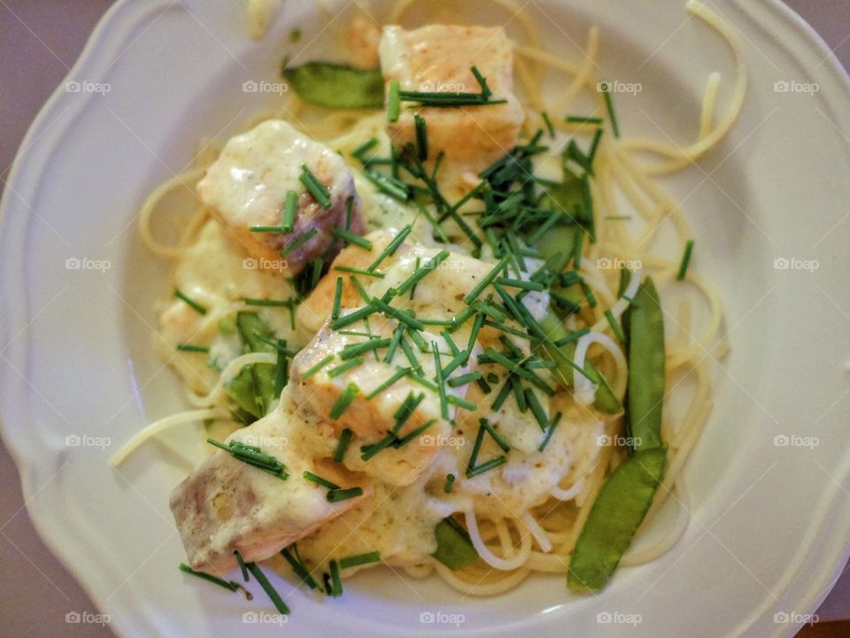 Salmon dish with chives and spagetti  