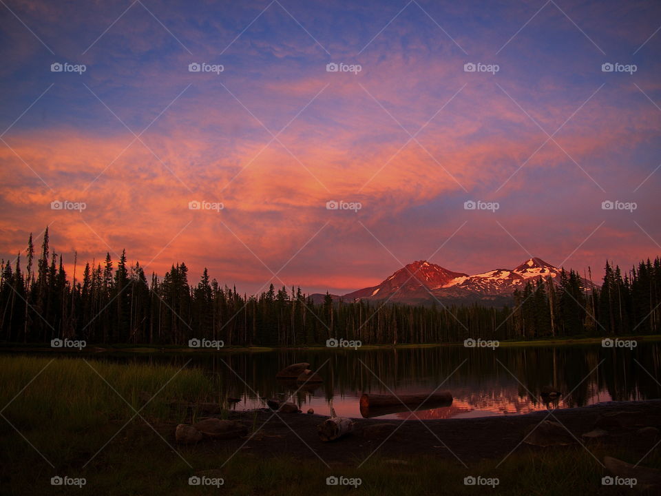 Scott Lake reflects a sunset over two of the Three Sisters