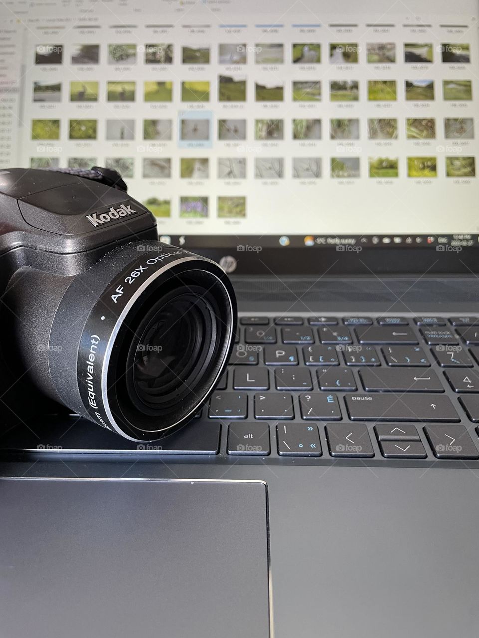 Focused more on the Kodak camera, sitting on my HP laptop, with photography downloaded on the screen in background, for my Foaper mission