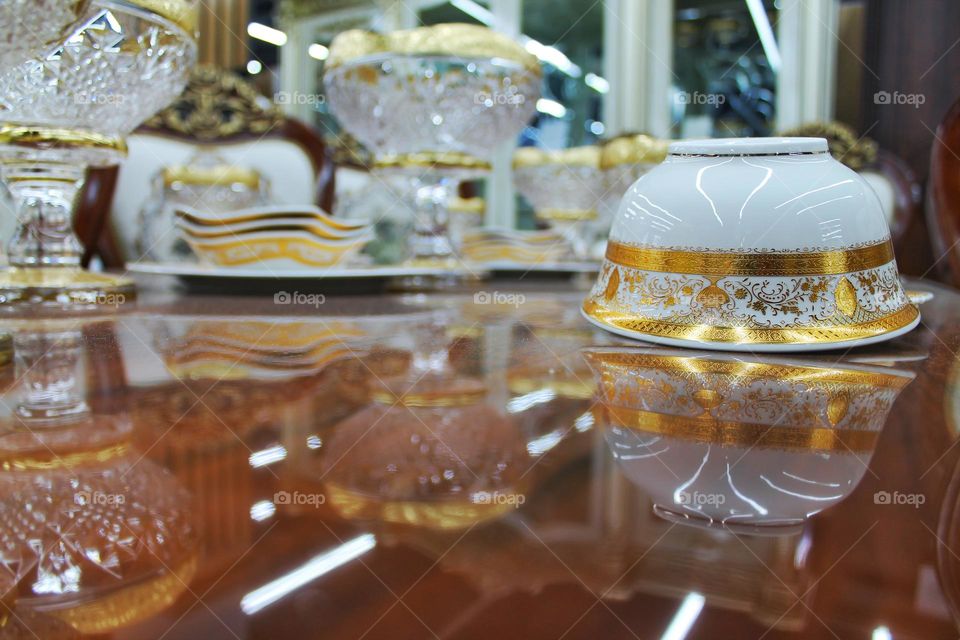 lacquered table and chic crockery with gilding pattern.