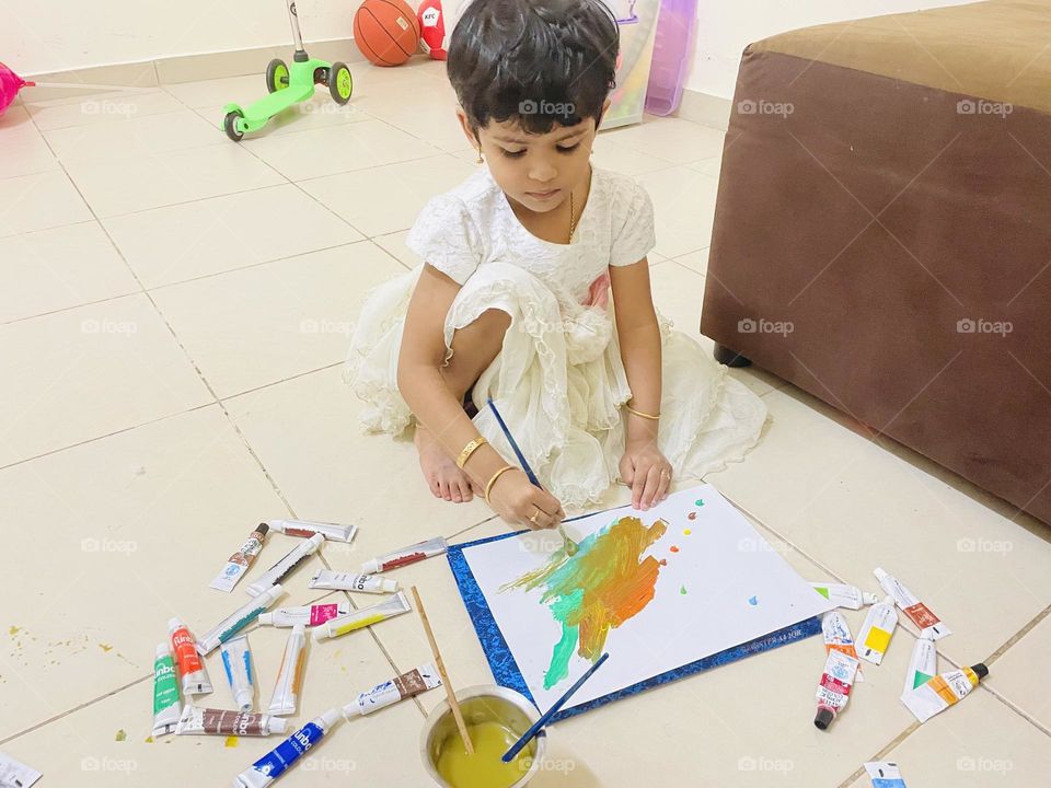 A child painting with colours