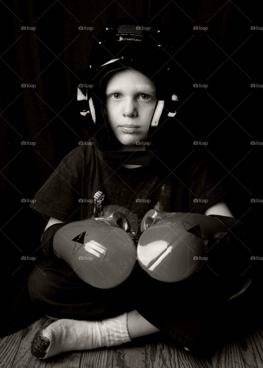 Ready to Rumble . A child puts on sparring gear and wants to play 