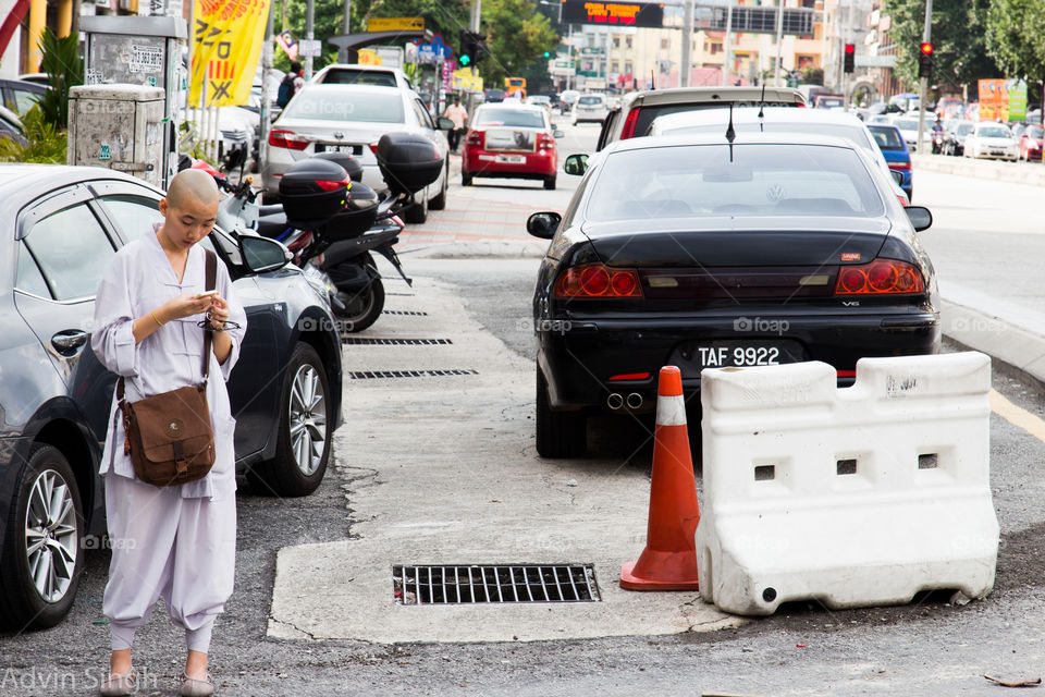 Ancient & New. I find it ironic a traditional monk is using her smartphone