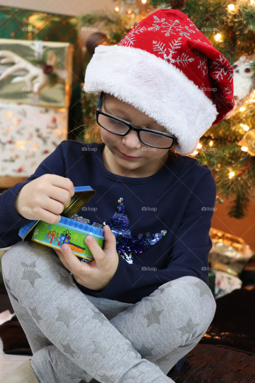 Toddler opening a present at Christmas