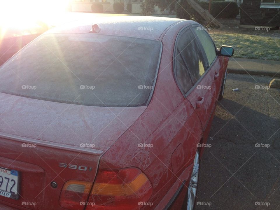 Frosty car in morning sun.