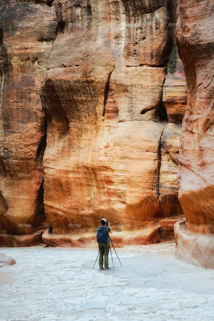 photographer taking pictures of the rock of Petra in Jordan