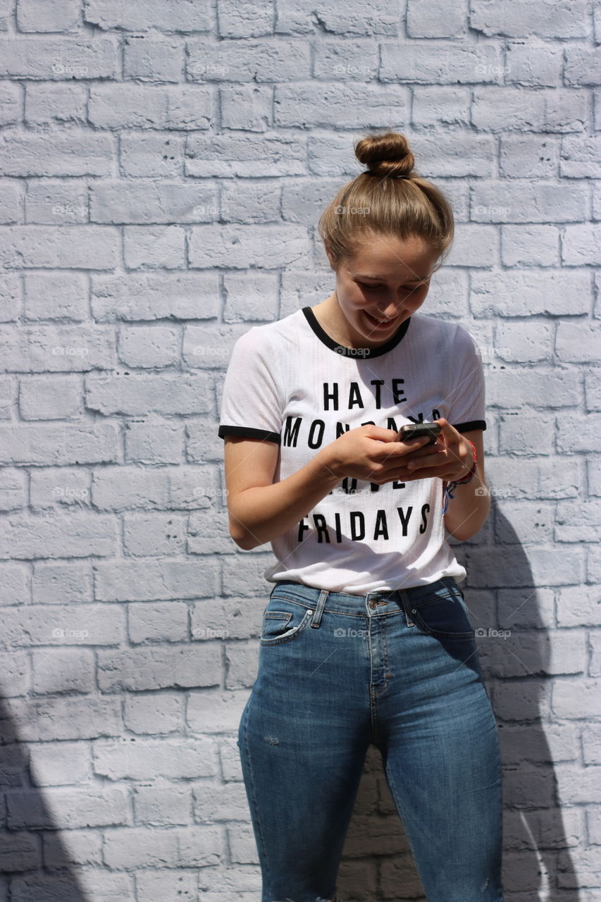 Smiling woman holding smartphone in hands